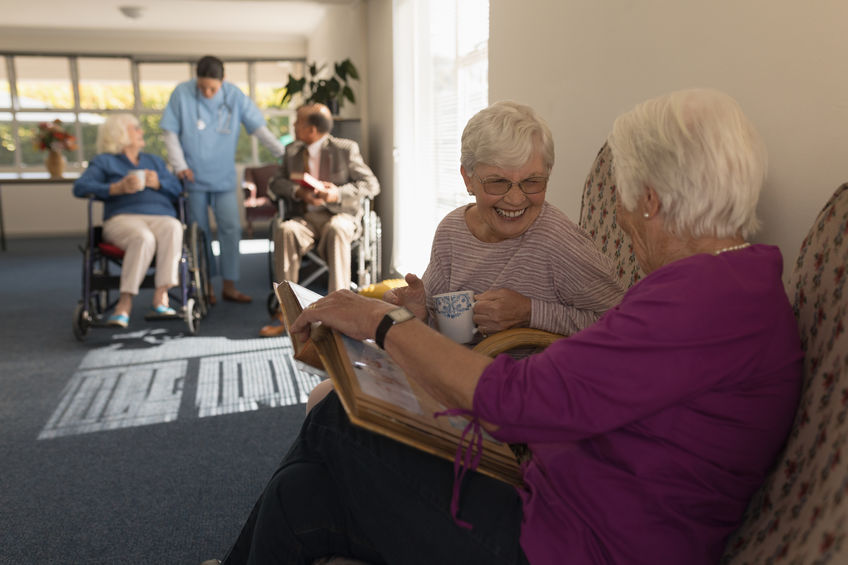 Side view of senior citizens socializing at an assisted living facility